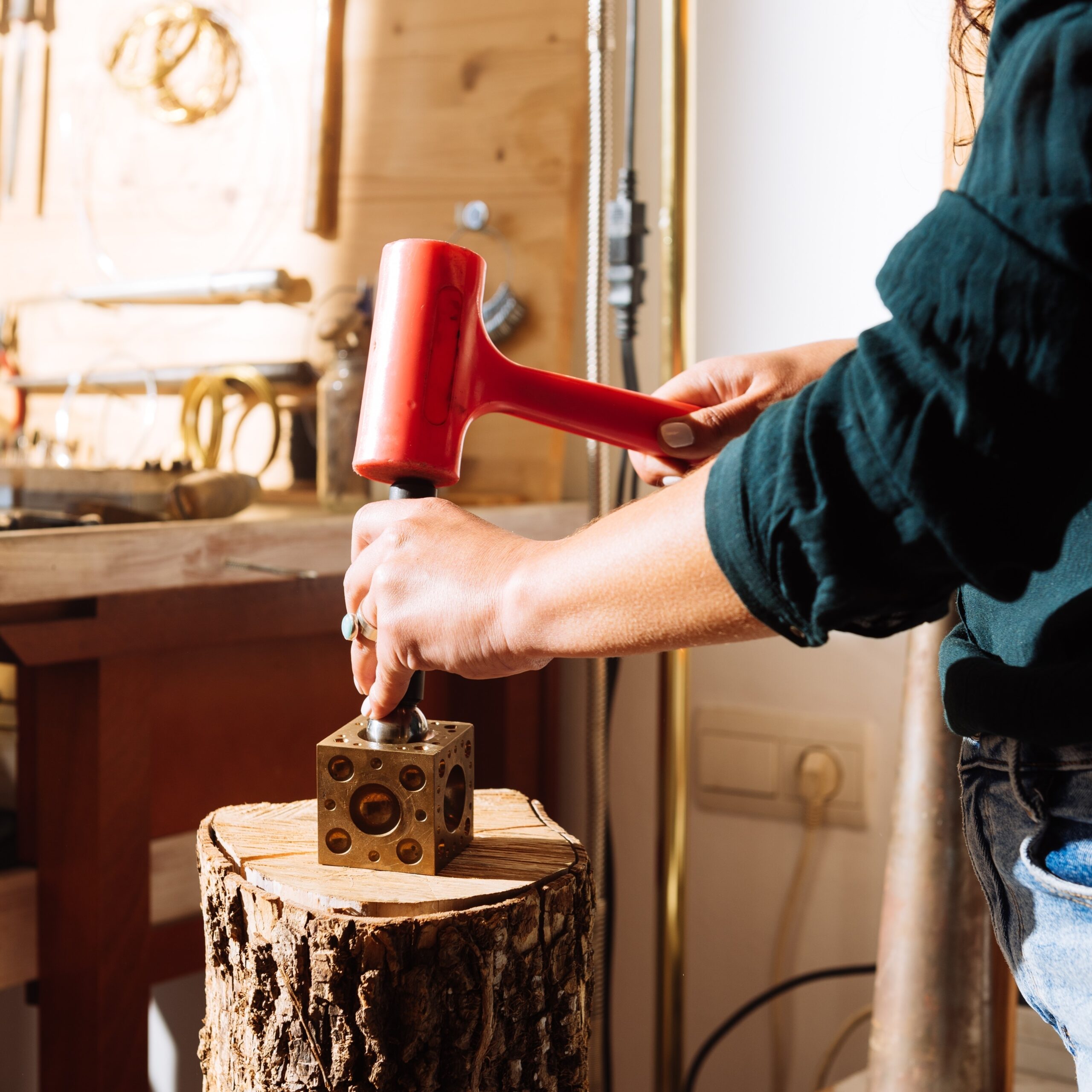 A goldsmith using a ball punch fot dapping
